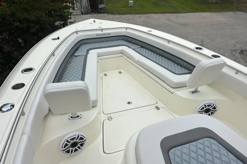 Slide: The Image of 2026 ShearWater 260 SS Carolina boat interior with cushioned seating and speakers. - 18