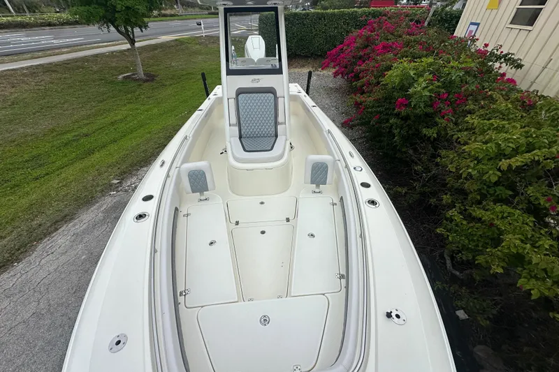 Slide: The Image of 2026 ShearWater 260 SS Carolina boat, white deck, lush greenery background. - 19