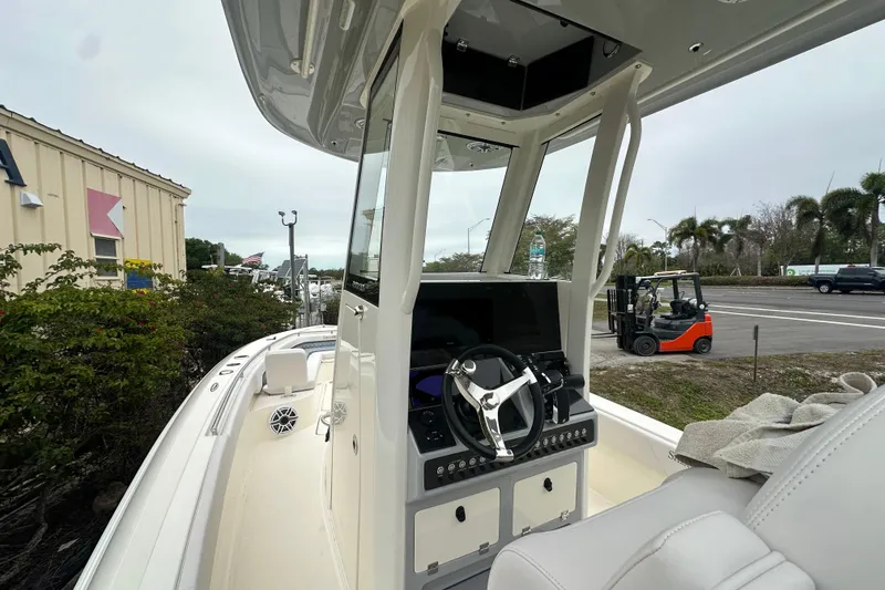 Slide: The Image of 2026 ShearWater 260 SS Carolina boat interior with steering console and seating. - 6