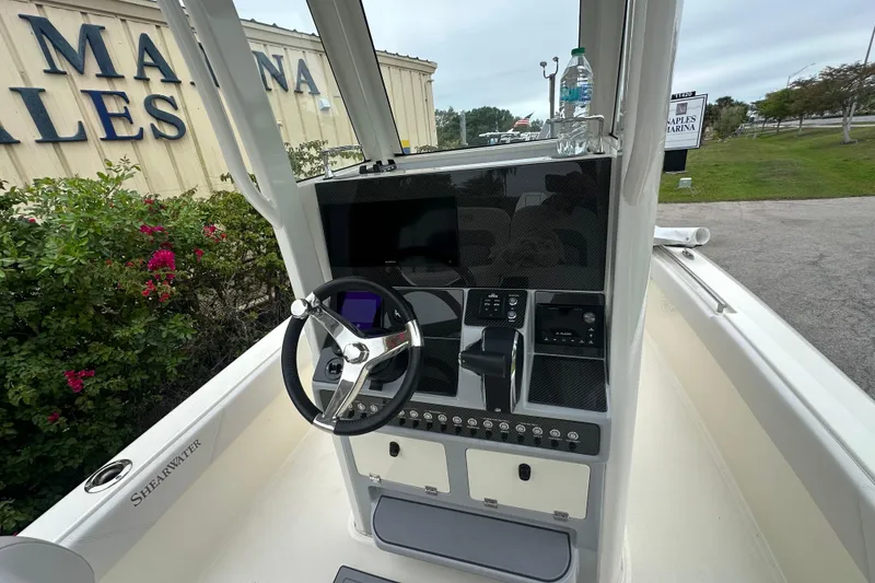 Slide: The Image of 2026 ShearWater 260 SS Carolina boat console with steering wheel and controls. - 7