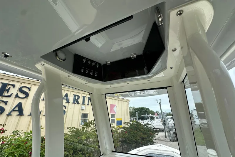 Slide: The Image of Interior view of 2026 ShearWater 260 SS Carolina boat's helm station with overhead console. - 9