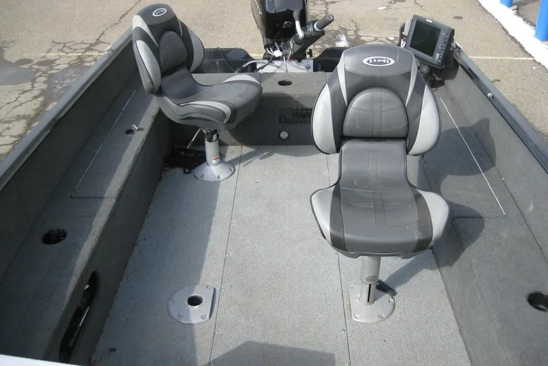 Slide: The Image of 2015 Lund 1650 Rebel XL Tiller boat interior with two seats and control panel. - 14