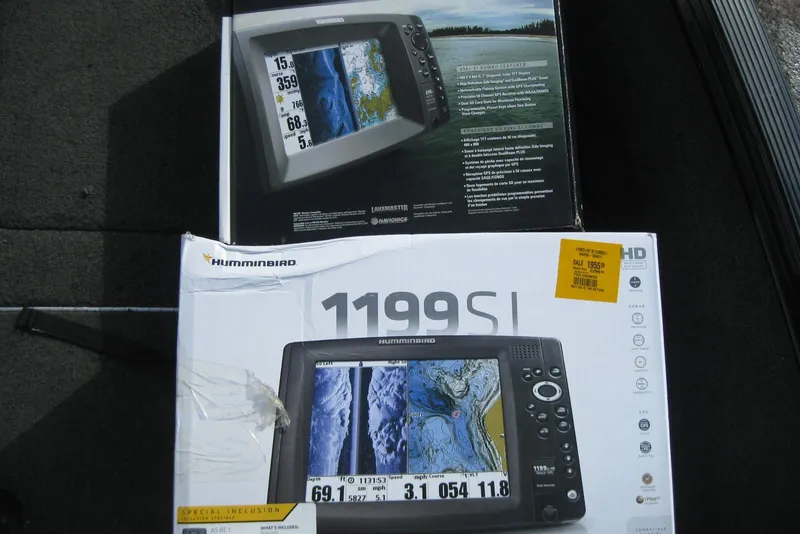 Slide: The Image of Boxes of Humminbird 1199 SI fish finders on a Lund 1650 Rebel XL Tiller boat. - 16
