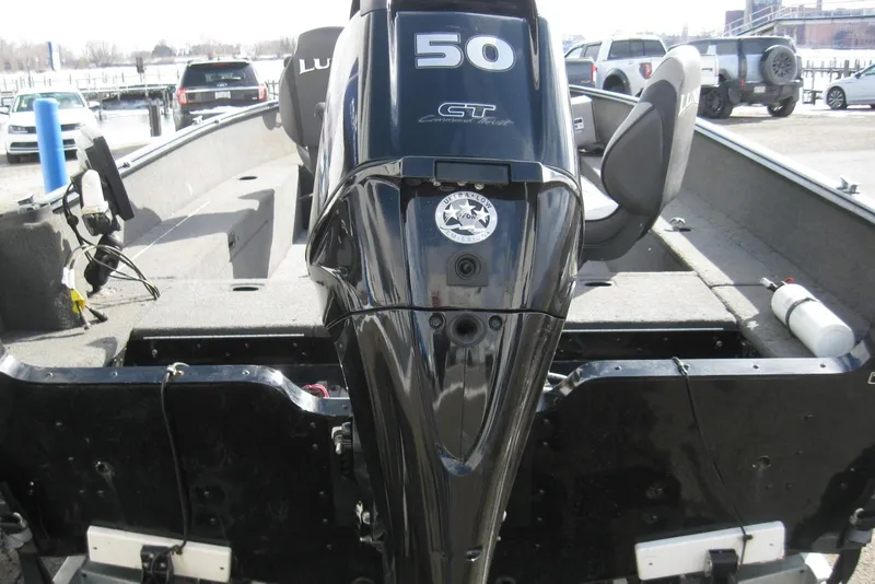 Slide: The Image of 2015 Lund 1650 Rebel XL Tiller boat with 50 HP motor, docked outdoors. - 5