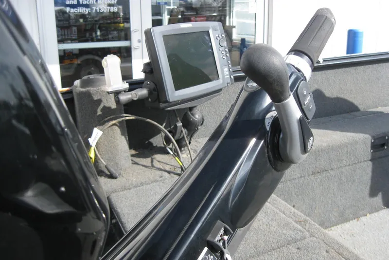 Slide: The Image of 2015 Lund 1650 Rebel XL Tiller boat interior with control handle and navigation screen. - 7