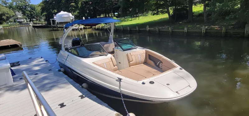 Slide: The Image of 2017 Sea Ray SDX 240 Outboard boat docked on a sunny day. - 1