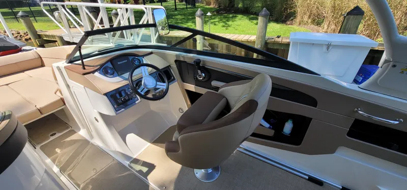 Slide: The Image of 2017 Sea Ray SDX 240 Outboard boat interior with helm and seating area. - 11