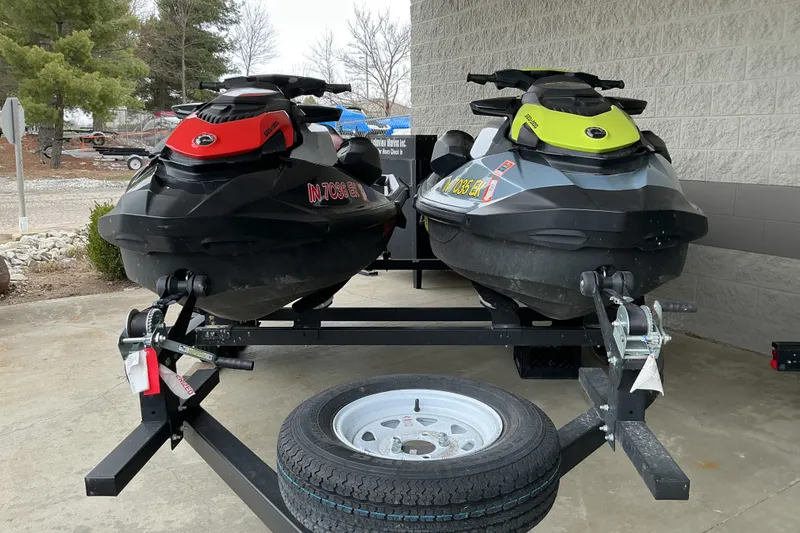 Slide: The Image of Two 2022 Sea-Doo GTI SE 170 jet skis on a trailer, parked outdoors. - 10