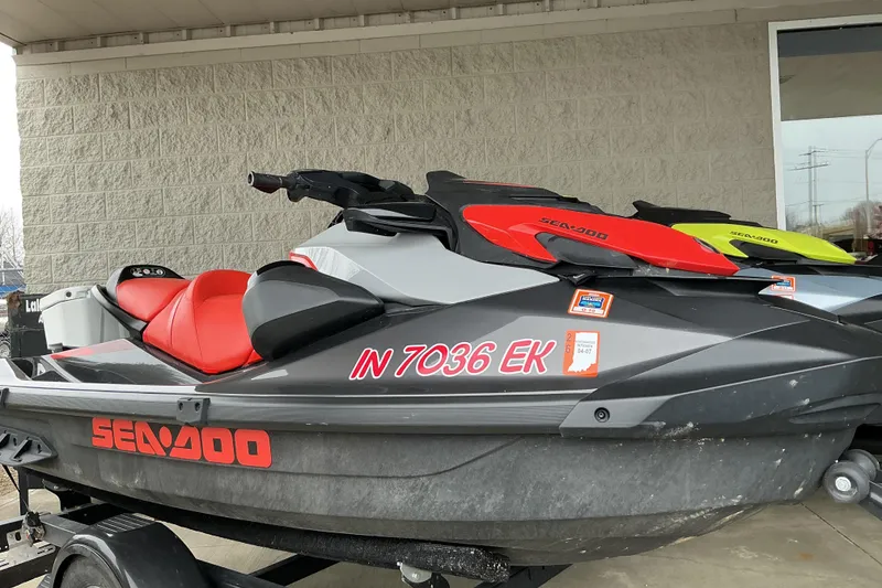 Slide: The Image of 2022 Sea-Doo GTI SE 170 jet ski with red seat, parked on trailer. - 8