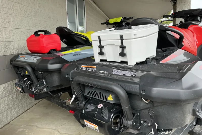 Slide: The Image of 2022 Sea-Doo GTI SE 170 jet skis with storage boxes and fuel containers. - 9