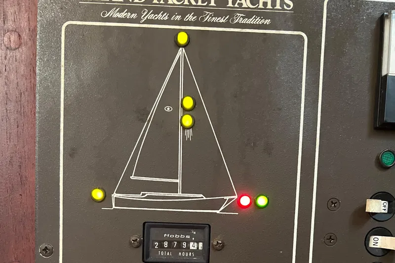 Slide: The Image of Control panel of a 1989 Island Packet Cutter yacht with indicator lights and hour meter. - 13