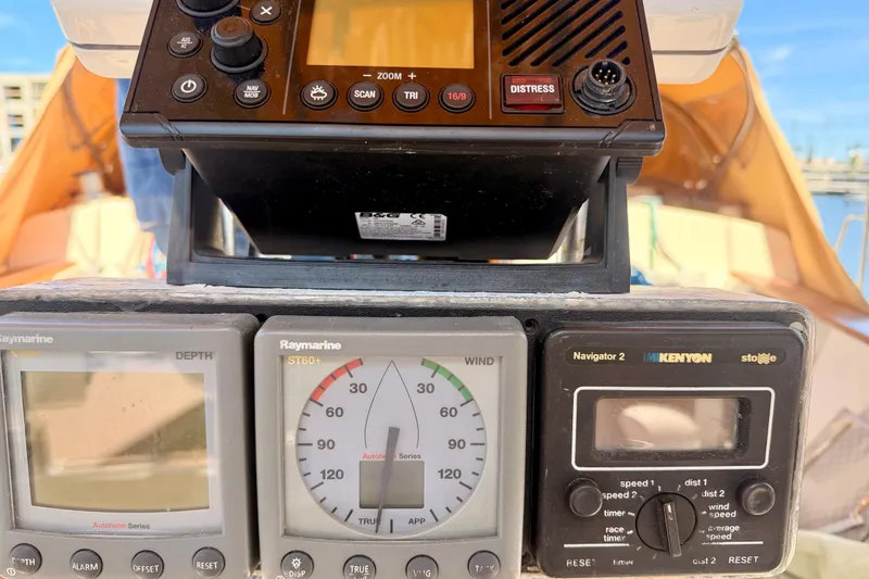 Slide: The Image of 1989 Island Packet Cutter cockpit instruments, featuring Raymarine and Kenyon navigation displays. - 17