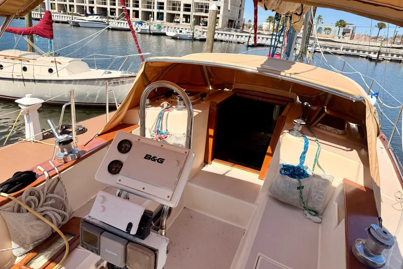 Slide: The Image of 1989 Island Packet Cutter sailboat cockpit with navigation equipment, docked at marina. - 18