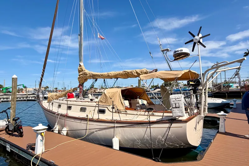 Slide: The Image of 1989 Island Packet Cutter sailboat docked at marina under clear blue sky. - 21