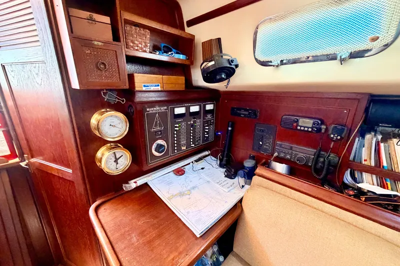 Slide: The Image of Navigation station on a 1989 Island Packet Cutter sailboat with instruments and charts. - 5