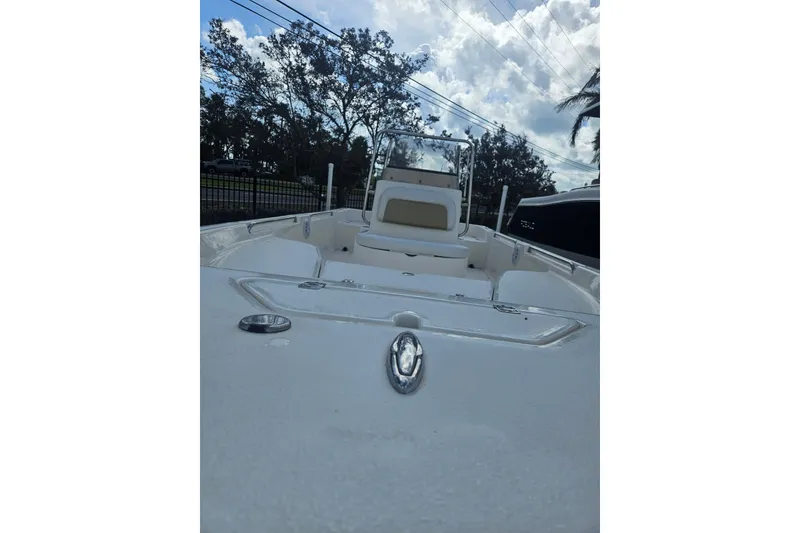Slide: The Image of 2018 Bulls Bay 2000 boat with seating, viewed from the bow under a cloudy sky. - 10