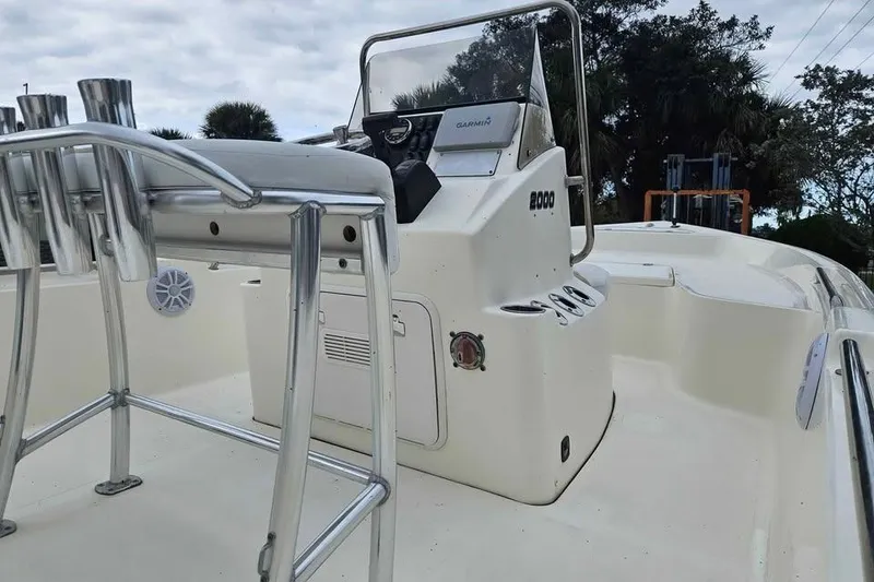 Slide: The Image of 2018 Bulls Bay 2000 boat interior with console and seating, under a cloudy sky. - 11