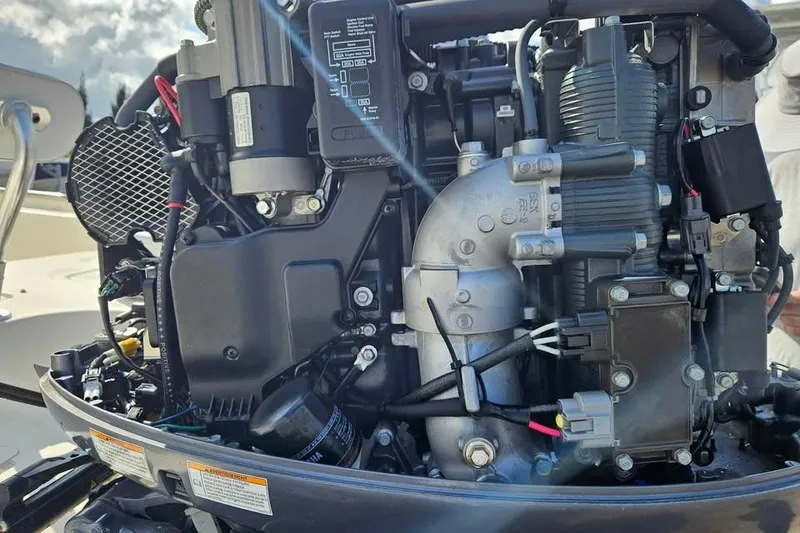 Slide: The Image of Close-up of a 2018 Bulls Bay 2000 boat engine, showcasing intricate mechanical components. - 13