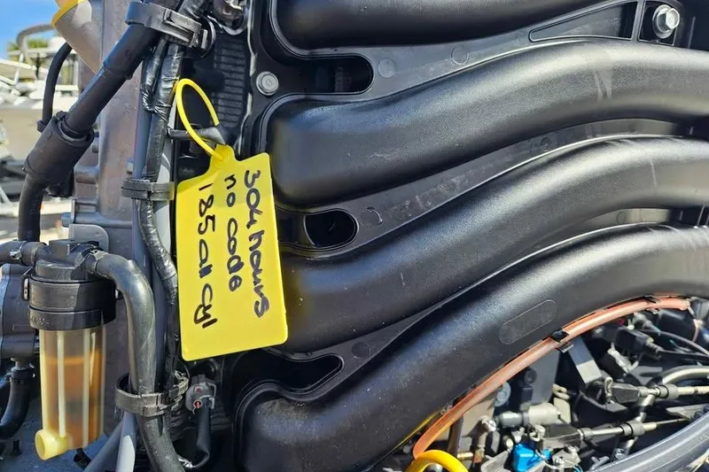 Slide: The Image of Close-up of a 2018 Bulls Bay 2000 engine with a yellow maintenance tag. - 14