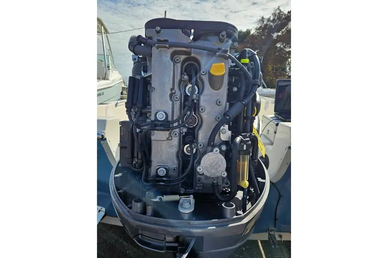 Slide: The Image of Close-up of a 2018 Bulls Bay 2000 boat engine, showcasing intricate mechanical details. - 15
