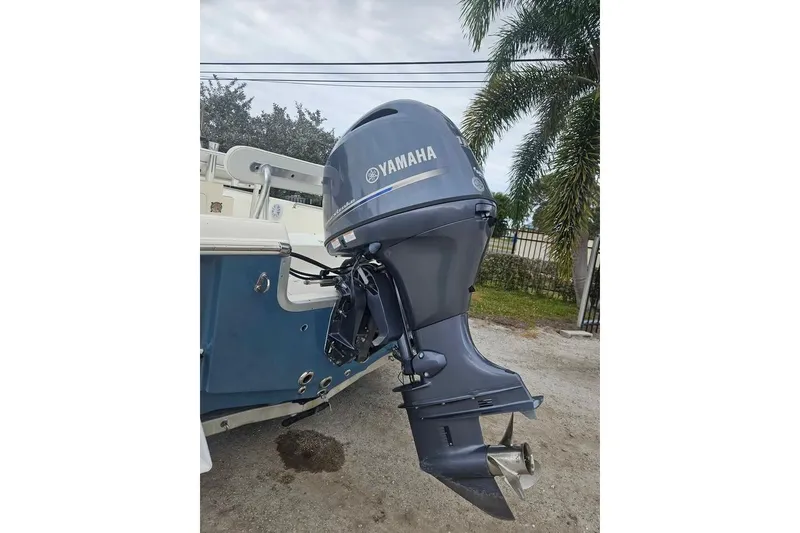 Slide: The Image of 2018 Bulls Bay 2000 boat with Yamaha outboard motor, parked near palm trees. - 5