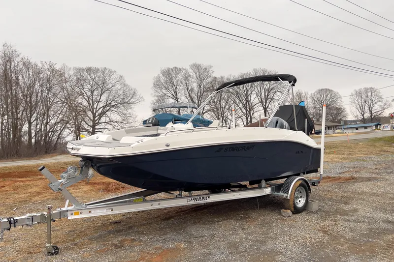 The Image of 2026 Starcraft SVX 171 OB boat on trailer, parked outdoors on gravel. - 0