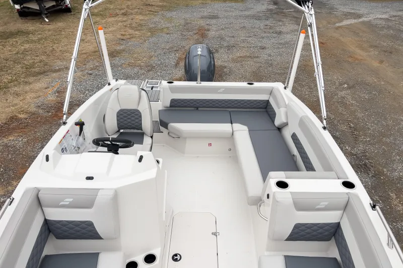 Slide: The Image of 2026 Starcraft SVX 171 OB boat interior with gray seating and steering console. - 3