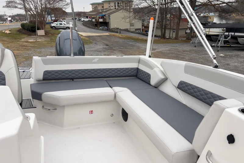 Slide: The Image of 2026 Starcraft SVX 171 OB boat interior with gray and white seating, docked outdoors. - 8