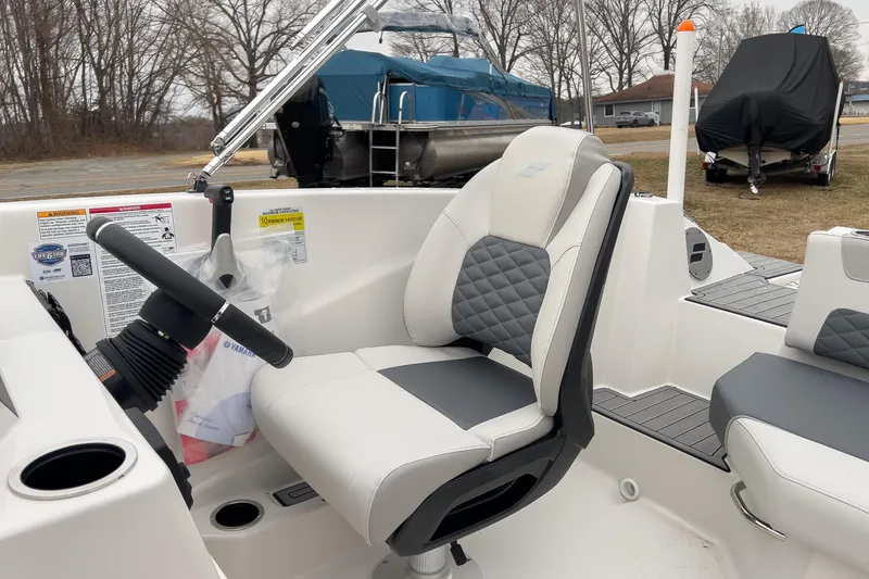 Slide: The Image of 2026 Starcraft SVX 171 OB boat interior with steering wheel and cushioned seating. - 9