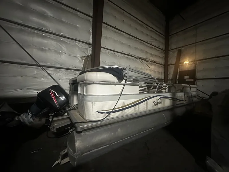 The Image of 2006 Sylvan 8522 Mirage Cruise RE pontoon boat in storage facility. - 0