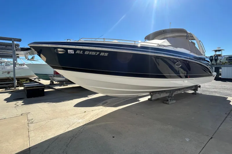 The Image of 2021 Formula 350 Crossover Bowrider I/O boat on display under clear blue sky. - 0