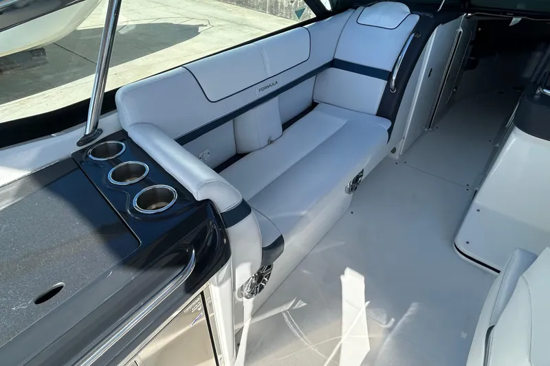 Slide: The Image of 2021 Formula 350 Crossover Bowrider I/O interior with white seating and cup holders. - 11