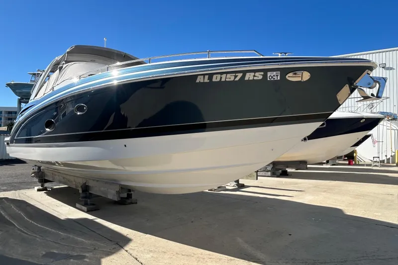 Slide: The Image of 2021 Formula 350 Crossover Bowrider I/O boat displayed outdoors on a sunny day. - 2