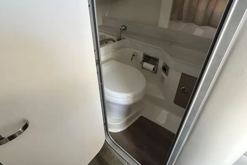 Slide: The Image of Interior of 2021 Formula 350 Crossover Bowrider I/O with storage, trash bin, and fire extinguisher. - 25