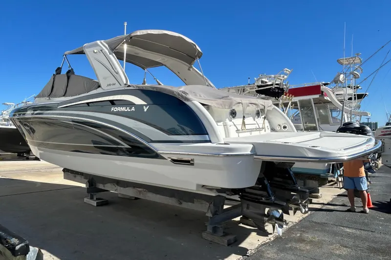 Slide: The Image of 2021 Formula 350 Crossover Bowrider I/O on display at a marina. - 3