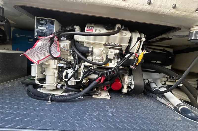 Slide: The Image of Engine compartment of a 2021 Formula 350 Crossover Bowrider I/O with various hoses and components. - 32