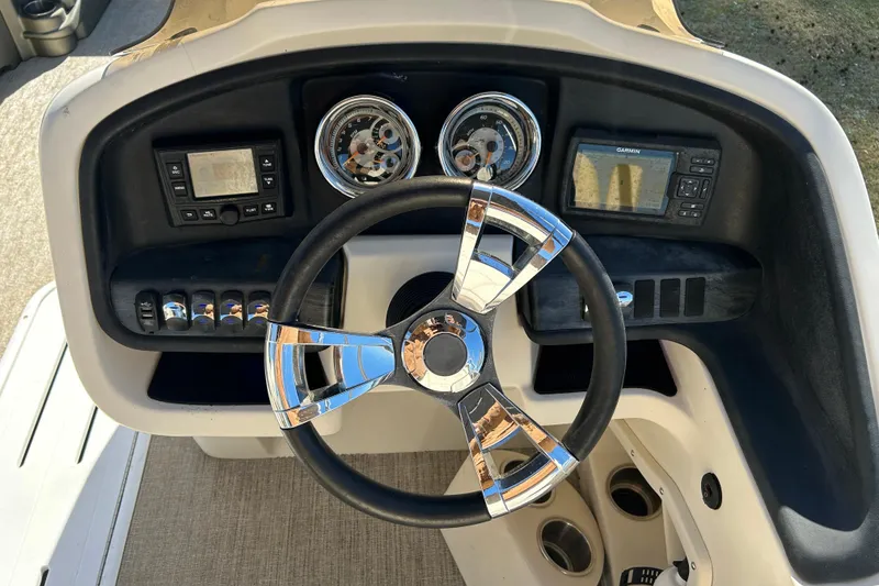 Slide: The Image of Steering console of 2020 Tahoe Pontoon Cascade Platinum Quad Lounger 23' with gauges and controls. - 10