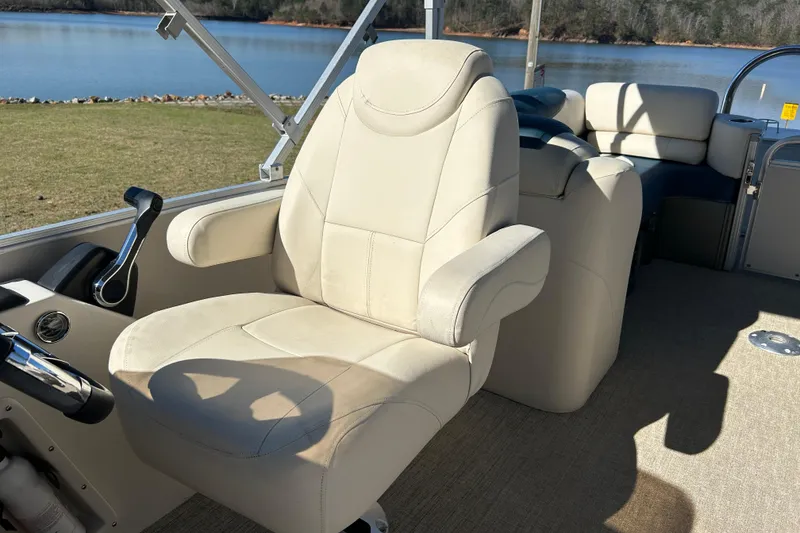 Slide: The Image of Luxurious captain's chair on 2020 Tahoe Pontoon Cascade Platinum Quad Lounger, overlooking serene lake. - 11