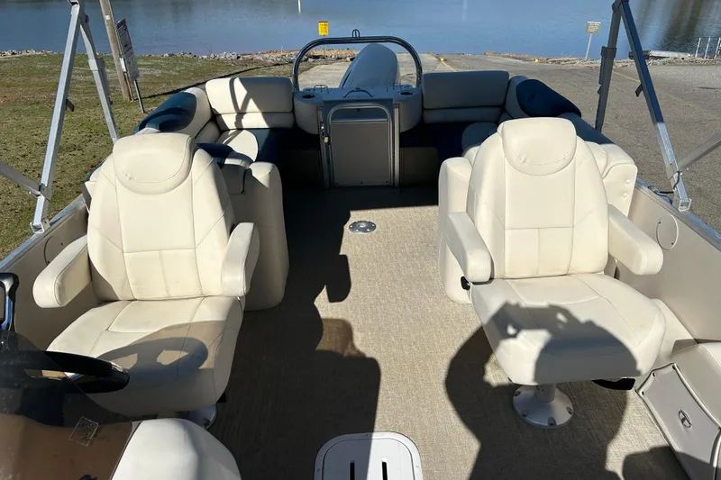 Slide: The Image of 2020 Tahoe Pontoon Cascade Platinum Quad Lounger 23' interior with plush seating and steering console. - 12