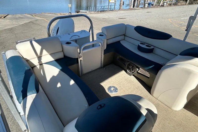 Slide: The Image of 2020 Tahoe Pontoon Cascade Platinum Quad Lounger 23' interior with plush seating and cup holders. - 13
