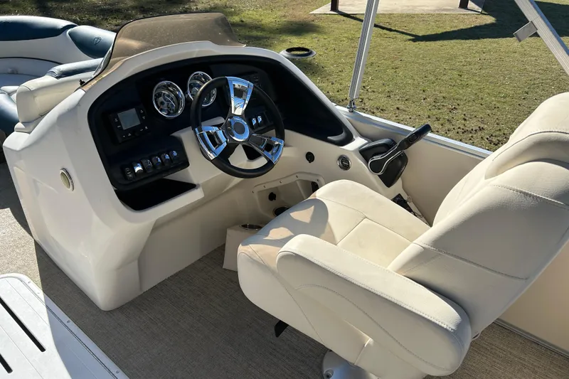Slide: The Image of 2020 Tahoe Pontoon Cascade Platinum Quad Lounger 23' helm with steering wheel and controls. - 9