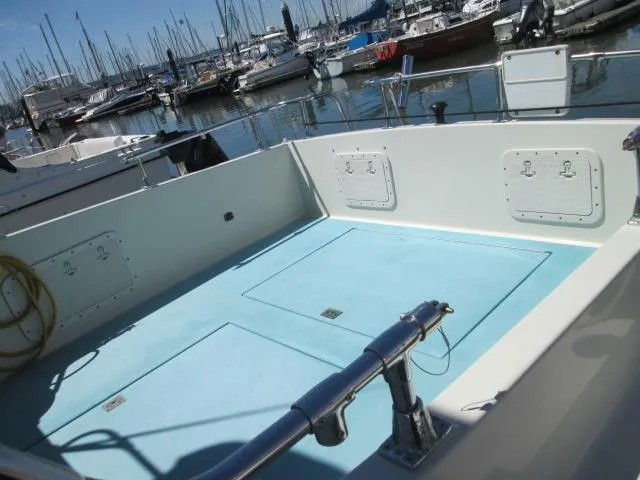 Slide: The Image of 1976 Tollycraft 26 Sedan at dock, spacious deck. - 10