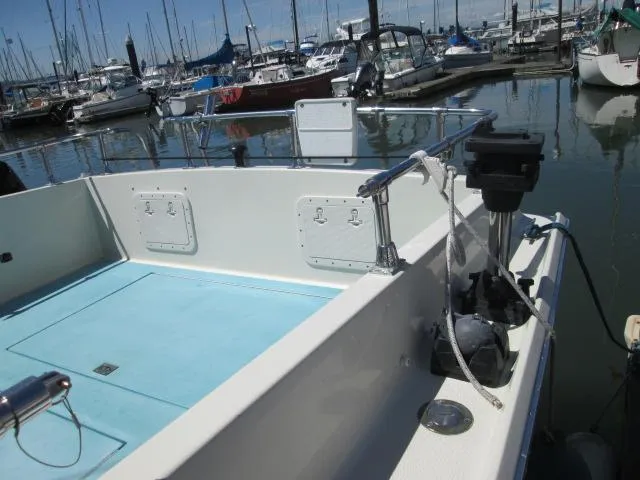 Slide: The Image of 1976 Tollycraft 26 Sedan in harbor, blue deck, calm waters. - 11