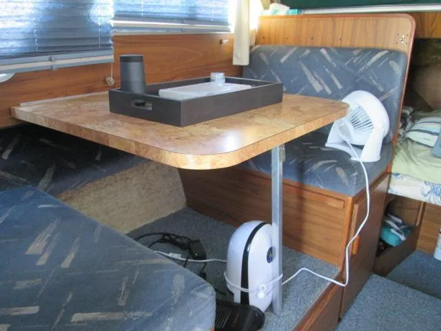 Slide: The Image of Interior of a 1976 Tollycraft 26 Sedan with table and seating area. - 36