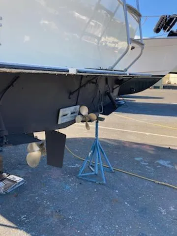 Slide: The Image of Rear view of a 1976 Tollycraft 26 Sedan on a boat stand. - 4