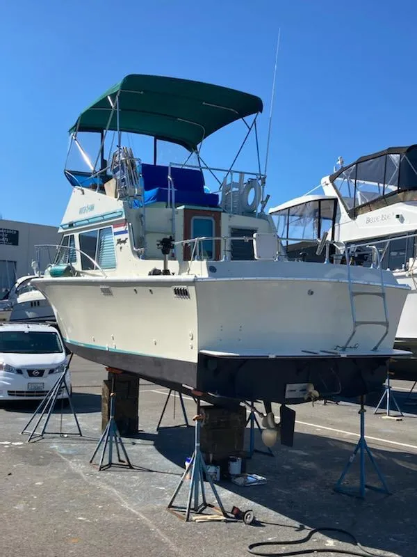 Slide: The Image of 1976 Tollycraft 26 Sedan on a boat lift in the harbor. - 5