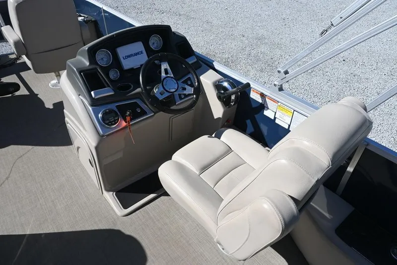 Slide: The Image of 2018 Ranger 223F boat cockpit with steering wheel and control panel. - 11