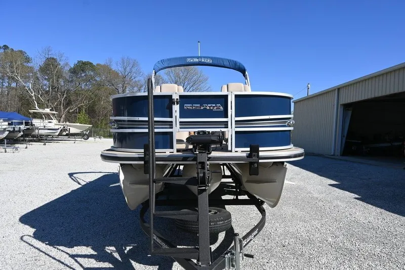 Slide: The Image of 2018 Ranger 223F pontoon boat on trailer in outdoor storage area. - 3