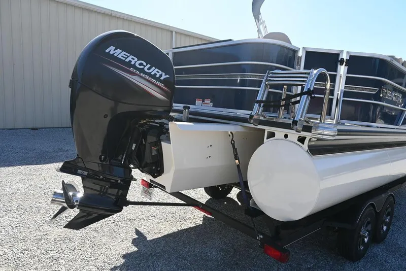 Slide: The Image of 2018 Ranger 223F boat with Mercury outboard motor, parked on gravel. - 4