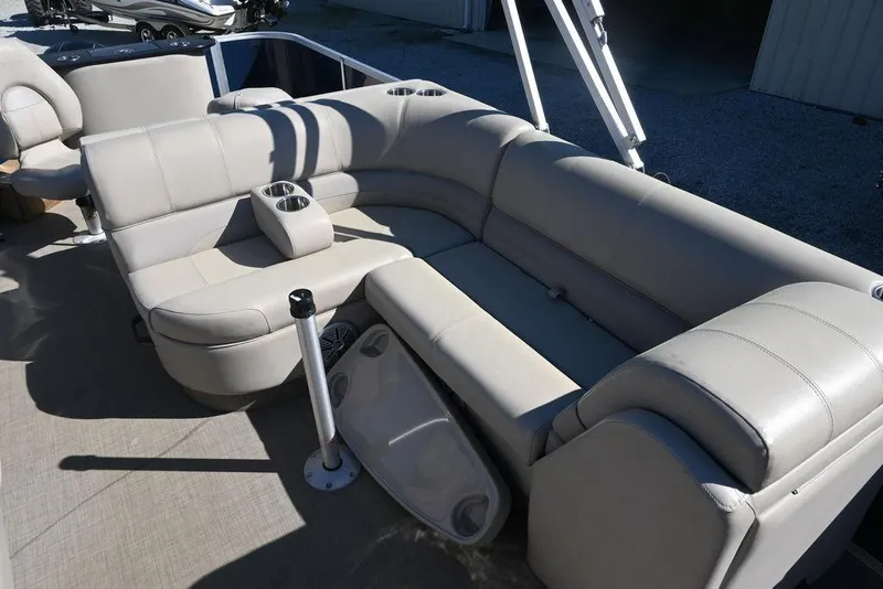 Slide: The Image of 2018 Ranger 223F boat interior with beige seating and cup holders. - 5